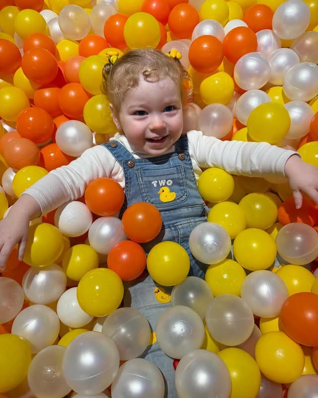 Happy toddler in custom Everleigh & Co dungarees